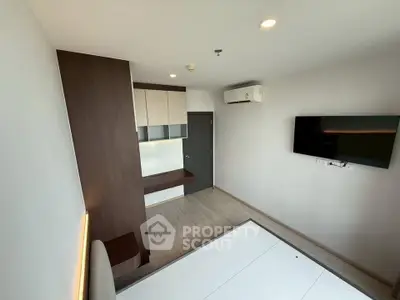 Modern minimalist bedroom with wall-mounted TV and air conditioning