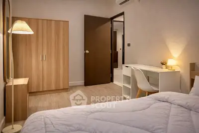 Cozy bedroom with modern furniture and warm lighting, perfect for relaxation and productivity.