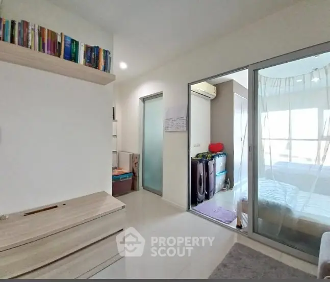 Spacious modern bedroom with sliding glass doors and ample natural light