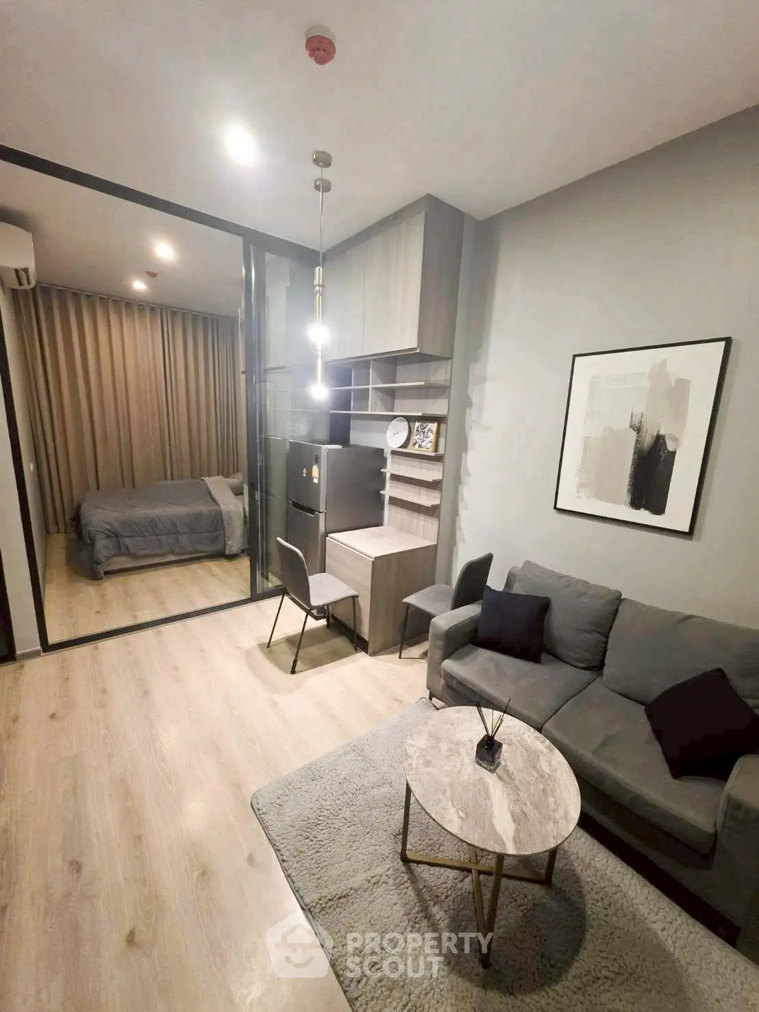 Modern studio apartment with cozy living area and stylish bedroom