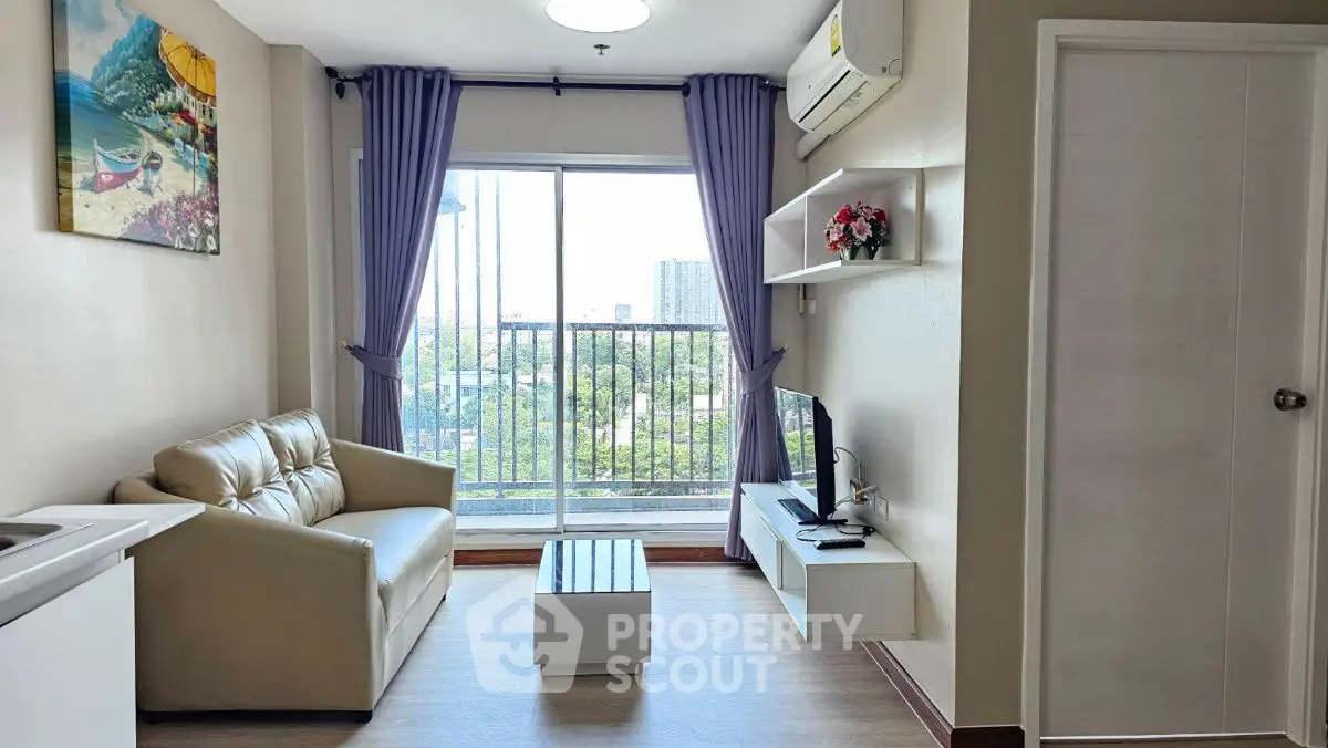 Modern living room with balcony view and stylish decor in urban apartment.