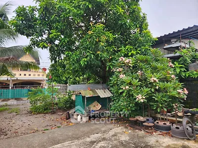 Charming garden area with lush greenery and outdoor seating, perfect for relaxation.