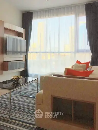 Modern living room with large window and stylish decor in urban apartment.