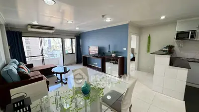 Modern open-plan living room with city view and stylish decor