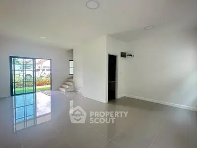 Spacious modern living room with glossy tiled floors and garden view