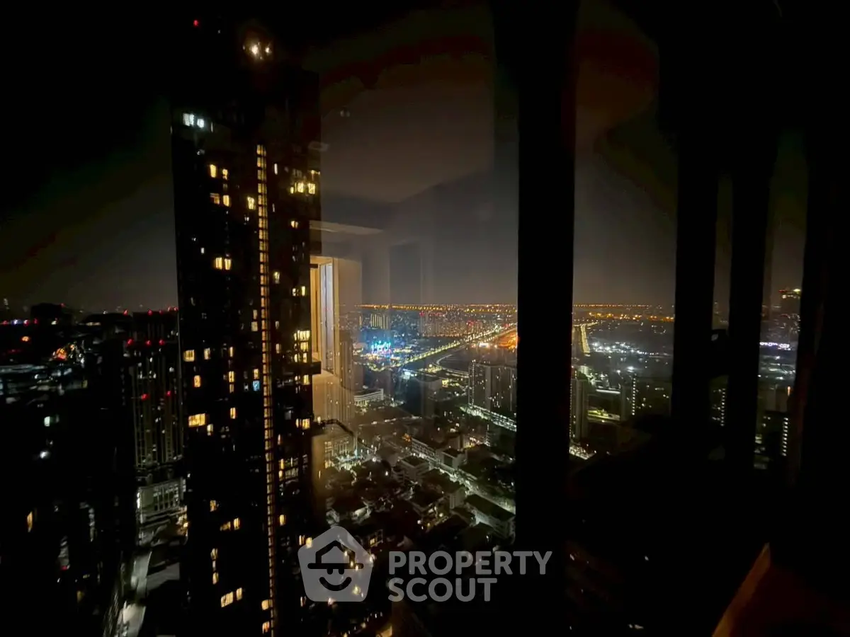 Stunning nighttime cityscape view from high-rise apartment window