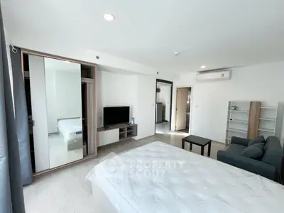 Spacious modern bedroom with sleek furniture and natural light