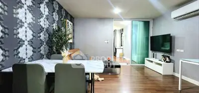 Modern living room with stylish decor and open layout, featuring a sleek dining area and cozy seating.