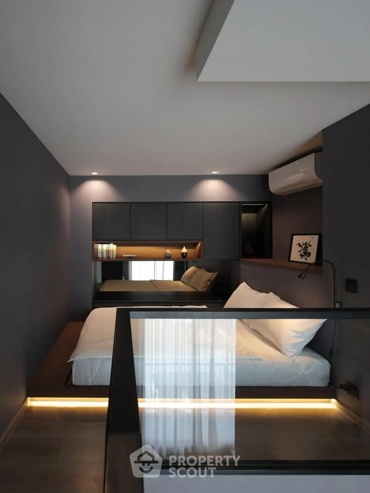Modern bedroom with sleek design and ambient lighting in a stylish apartment.