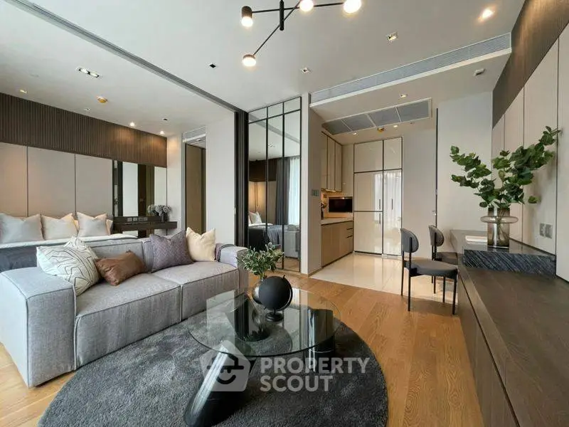 Modern living room with stylish decor and open kitchen layout in luxury apartment.