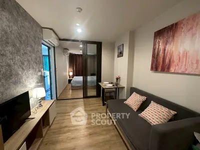 Modern living room with cozy sofa and stylish decor in a contemporary apartment.