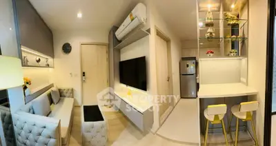 Modern living room with stylish decor and open kitchen layout in a cozy apartment.