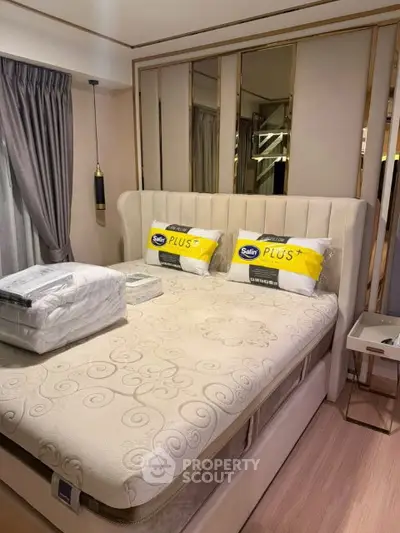 Luxurious bedroom with elegant decor and plush bedding in modern apartment.