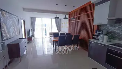 Spacious modern living room with dining area and stylish kitchen in open layout apartment.