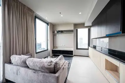 Modern living room with panoramic city views and sleek built-in cabinetry.
