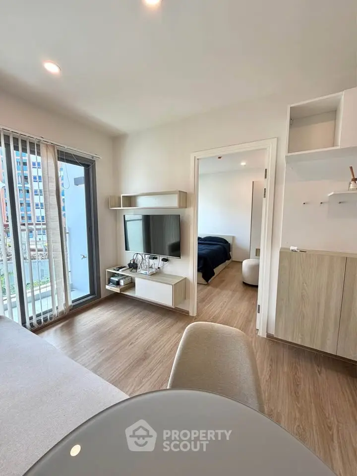 Modern living room with open layout and balcony access in a stylish apartment.