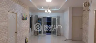 Spacious living room with elegant lighting and large windows for natural light.