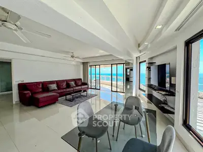 Stunning living room with ocean view, modern furniture, and sleek design.