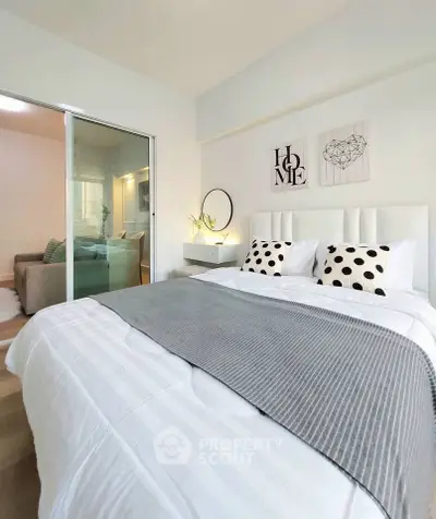 Modern bedroom with stylish decor and cozy bedding in a contemporary apartment.