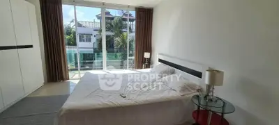 Spacious bedroom with large windows and balcony view in modern home