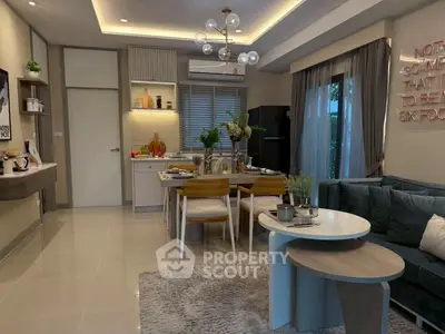 Stylish open-plan living room and kitchen with modern decor and cozy ambiance.