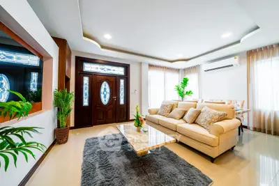 Spacious and elegant living room with modern decor and natural light