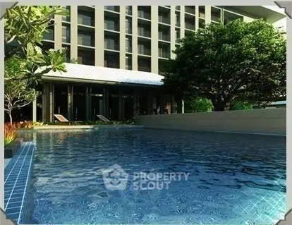 Luxurious residential building with serene pool and lush greenery, perfect for relaxation and leisure.