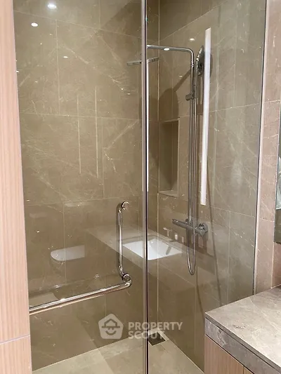 Modern bathroom with glass shower enclosure and sleek tile design