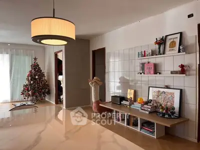 Stylish living room with modern decor and Christmas tree, featuring elegant lighting and a cozy atmosphere.