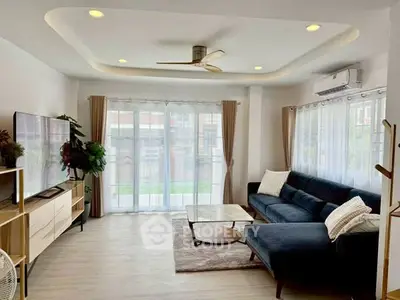 Spacious living room with modern decor and large windows for natural light.