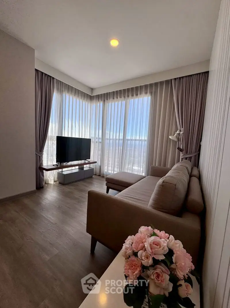 Bright and cozy living room with corner sofa and large windows offering stunning views.