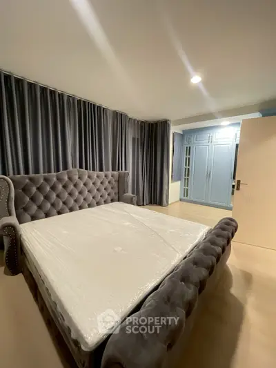 Luxurious bedroom with elegant tufted bed and stylish wardrobe