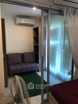 Cozy small living room with sliding glass doors and air conditioning
