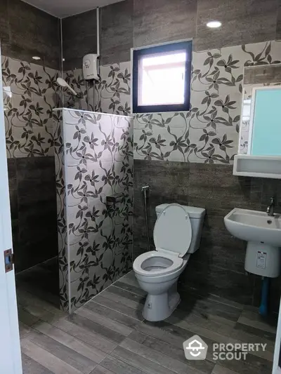 Modern bathroom with floral tile design and compact layout