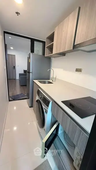 Modern kitchen with sleek appliances and open layout in a stylish apartment