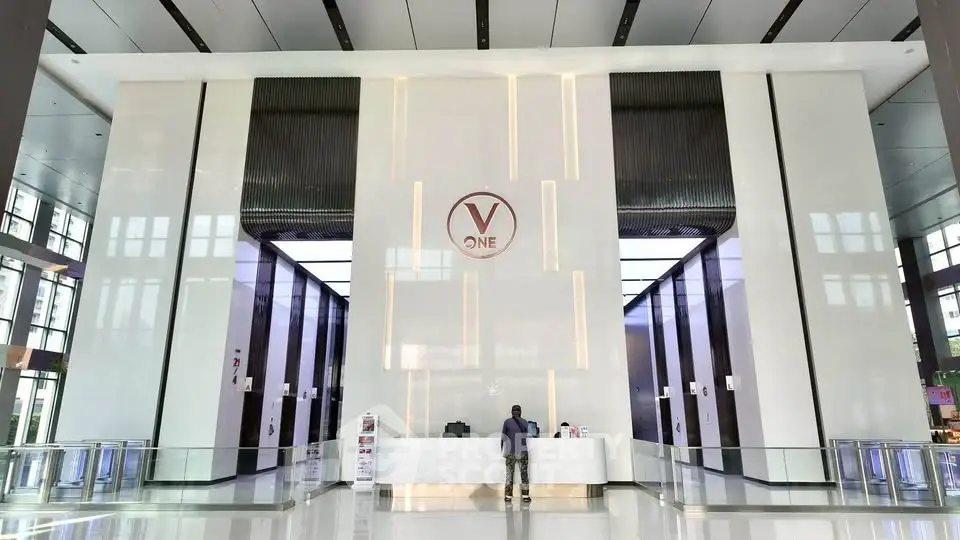 Luxurious modern building entrance with sleek design and high ceilings, perfect for upscale business or residential use.