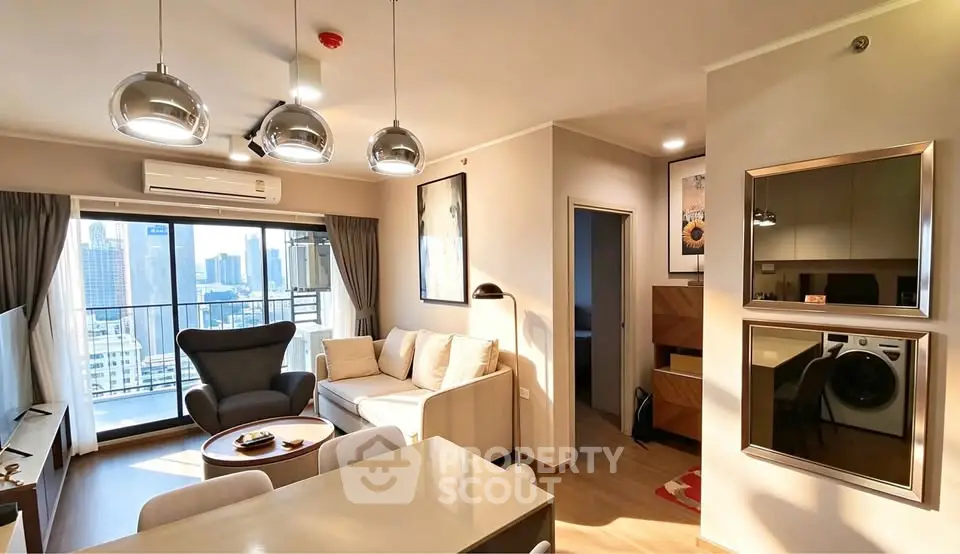 Modern living room with city view, stylish lighting, and cozy seating area in high-rise apartment.