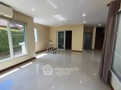 Spacious living room with large windows and natural light in modern home