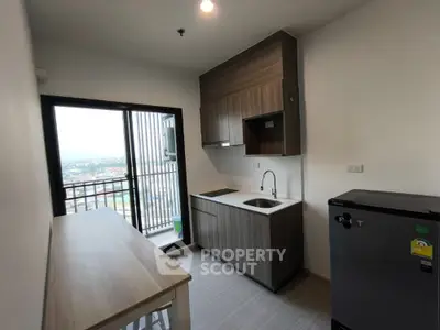 Modern kitchen with balcony view in high-rise apartment