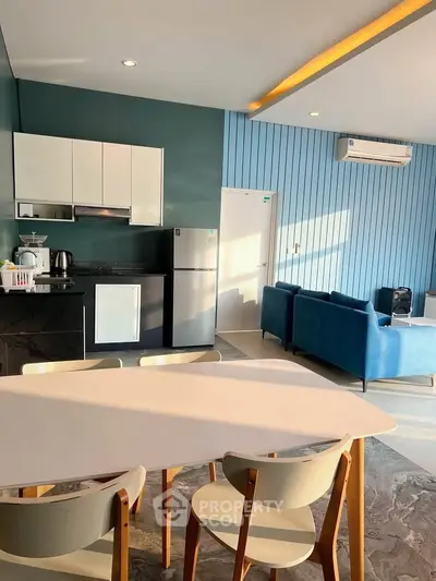Modern open-layout kitchen and living room with stylish furniture and natural light