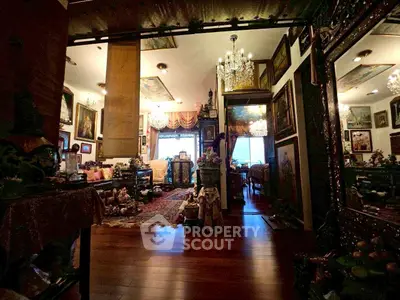 Luxurious living room with elegant decor and chandeliers, showcasing opulent interior design.