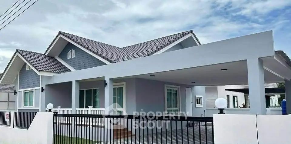 Modern single-story house with spacious carport and stylish facade.