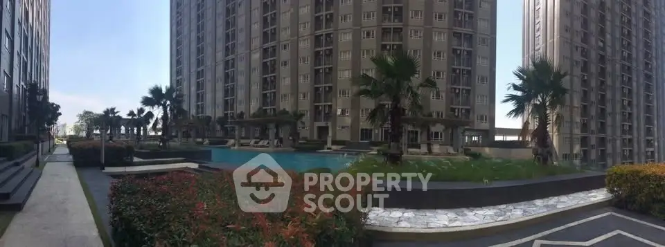 Luxurious high-rise apartment complex with stunning pool and lush landscaping.