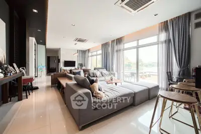 Spacious modern living room with large windows and stylish decor