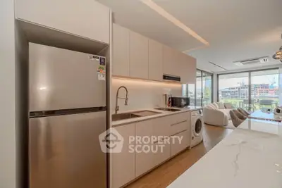 Modern kitchen with sleek cabinetry and integrated appliances in a bright open-plan living space.