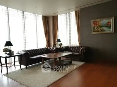 Elegant living room with leather sofas and large windows in luxury apartment