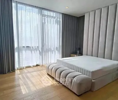 Luxurious bedroom with floor-to-ceiling windows and elegant decor