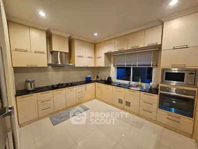 Spacious modern kitchen with sleek cabinetry and built-in appliances