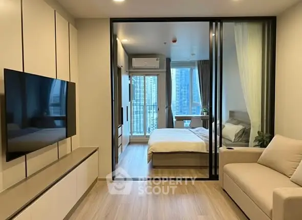 Modern apartment interior with sleek living room and cozy bedroom view.
