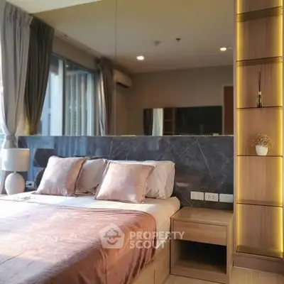 Luxurious bedroom with elegant decor and natural light, featuring a stylish headboard and modern shelving.